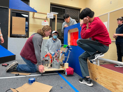 a group of students testing a prototype mechanism