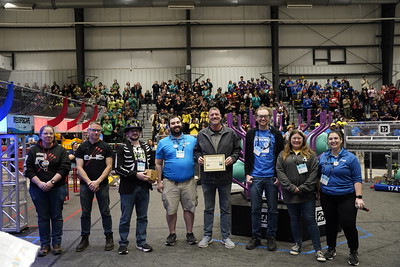 a group of our mentors that serve on the planning committee for the Lafayette FRC event handing out an award